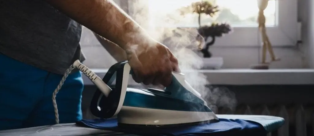 Man Ironing On Iron Board