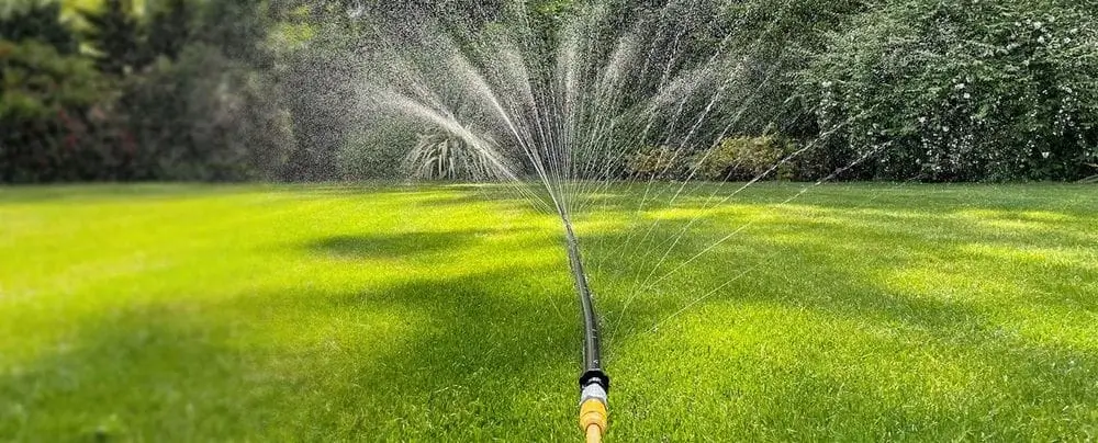 Home Sprinkler On Green Lawn