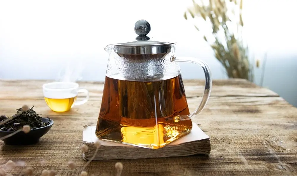 Teapot On Wood Desk Beside Window